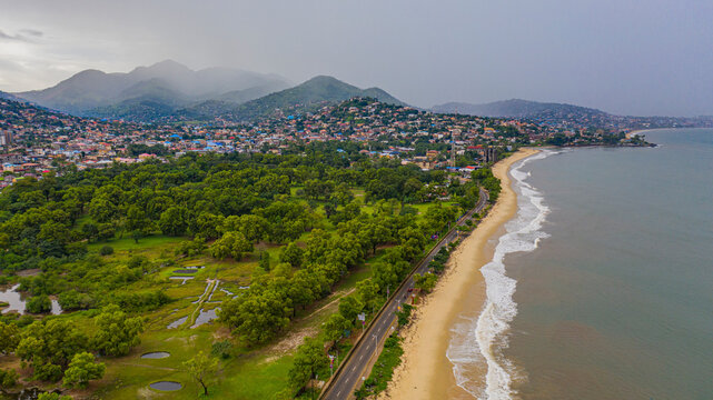 Aerial view of a beautiful sandy beach with tranquil waves and lush greenery, Freetown, Sierra Leone.