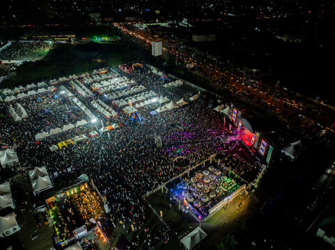 Aerial view of vibrant bole festival with crowded tents and dynamic lights, Obia, Nigeria.