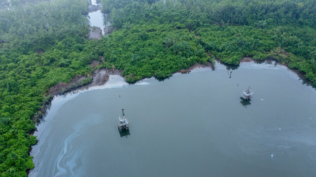 Aerial view of serene well head surrounded by lush greenery and water, Akuku-Toru, Nigeria.