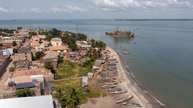 Aerial view of boats on shore with beautiful coastal landscape and urban architecture, Banjul, The Gambia.