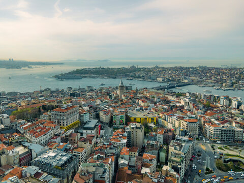 Aerial view of the historic skyline featuring the Galata Tower, Bosphorus Strait, and traditional buildings, Beyoglu, Turkiye.