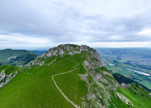 Aerial view of Stockhorn Mountain with a scenic hiking path under a cloudy sky, Erlenbach im Simmental, Switzerland.