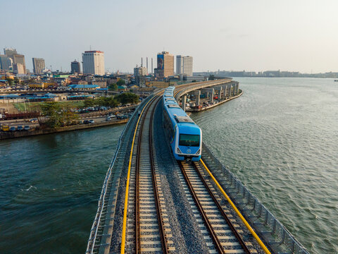 Aerial view of a beautiful urban cityscape with a railway bridge over water, Lagos, Nigeria.