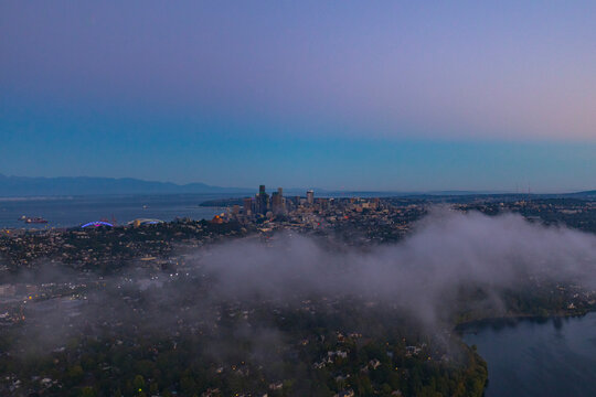 Aerial view of seattle skyline at dawn with fog and olympic mountains, seattle, united states.