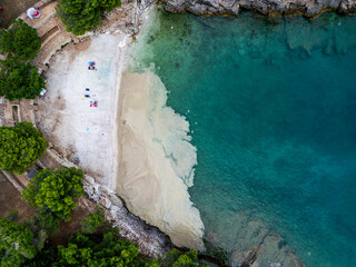 Aerial view of a beautiful beach with algae accumulation and clear turquoise water, Pula, Croatia.