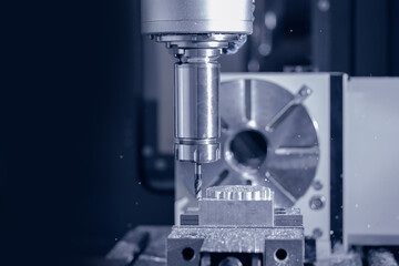 Fototapeta premium Closeup CNC milling machine during operation. Produced cutting metal parts, banner background of industry heavy factory