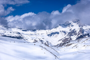 Snow cladded mountain view enroute Rupin pass trekking trail. It is a high altitude trek in...