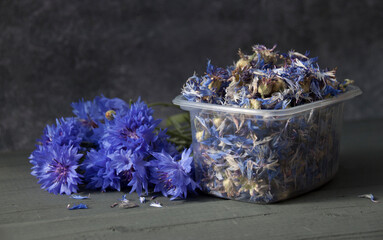 Dry cornflower flowers in a plastic container