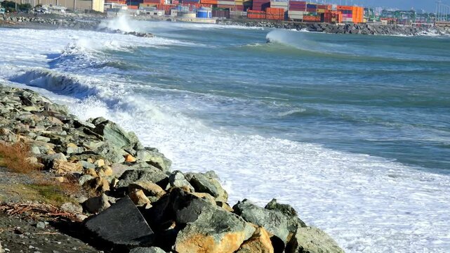 Coastal Port with Waves and Shipping Containers Under Mountains near Genoa Voltri