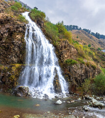 Fototapeta premium Drung Waterfall is located enroute to Gulmarg in Tangmarg, Baramulla district, Jammu and Kashmir. Drung Waterfall transforms into a captivating sight when it freezes during winter.