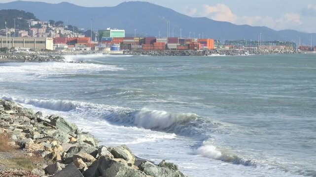 Coastal Port with Waves and Shipping Containers Under Mountains near Genoa Voltri