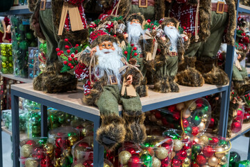 A festive Santa Claus figurine surrounded by vibrant Christmas decorations fills the store with holiday spirit and joy.