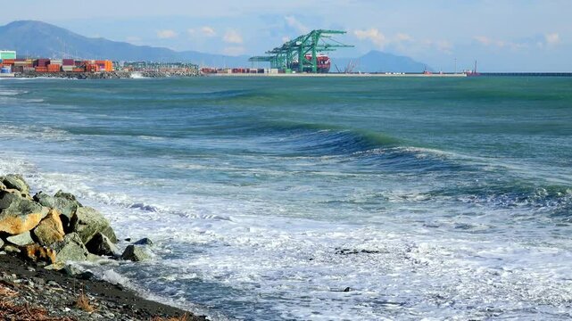 Coastal Port with Waves and Shipping Containers Under Mountains near Genoa Voltri
