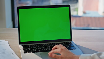 Programmer hand working laptop with green screen closeup. Unknown businesswoman