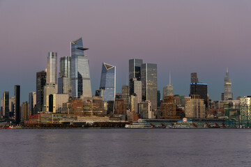 Midtown NYC skyline during sunset with Hudson River.