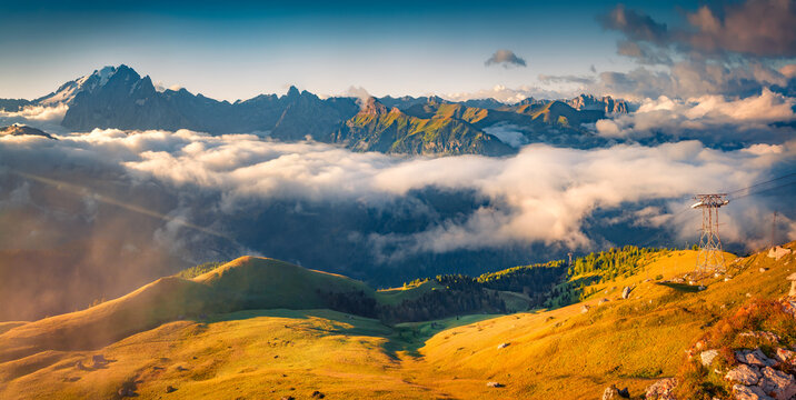 Foggy summer view of Val di Fassa valley. Imressive morning landscape of italian Alps from Sella pass. Amazing outdoor scane of Dolomite Alps, Italy, Europe. Beauty of nature concept background.