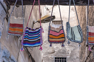 Canvas handbags displayed in an alley in the city of Fez. Morocco. Horizontally. 