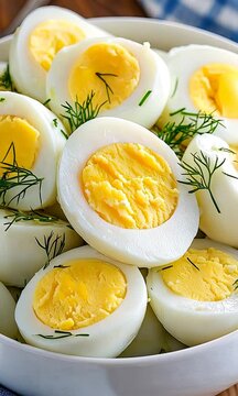 Hard boiled eggs are beautifully arranged in a bowl, garnished with fresh herbs, showcasing a nutritious and tasty option for meals or snacks