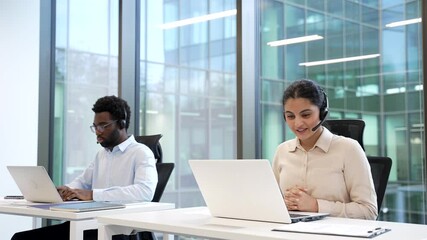 Team of Customer Service Representatives manager Working at Computers with Headsets Corporate operators technical support specialist consulting client call center Group friendly smiling Employee agent