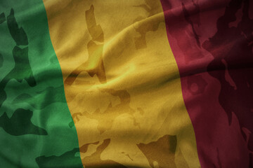 colourful waving flag of mali on the old army khaki texture background. military concept.