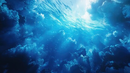 Obraz premium Underwater scene showcasing vibrant blue hues and dynamic clouds of water, evoking a sense of tranquility and depth.