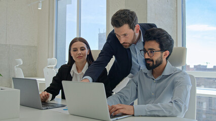 Male CEO boss leader man businessman help office coworkers with computer work check online project...
