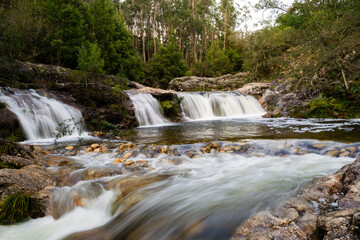 beautiful view of the waterfalls in the natural pool of Loureza. Oia - Spain