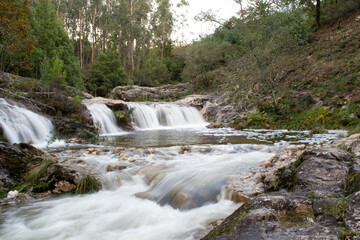 beautiful view of the waterfalls in the natural pool of Loureza. Oia - Spain