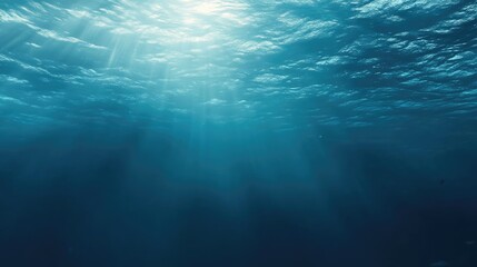 Naklejka premium Serene underwater scene showcasing tranquil blue hues and sunlight filtering through the surface.