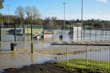 River burst it's banks in northamptonshire uk causing flooding the flood water covers local amenities and parkland