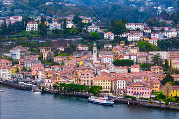 Obraz premium Aerial view of Italian small town Menaggio on shore lake Como, Italy with overcast day