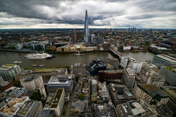 Obraz premium panoramic view of London, taken from a high building observation deck. The prominent feature is The Shard, a striking modern skyscraper dominating the skyline with its glassy, pointed structure.