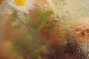 Soft focus  flower bouquet through glass with wet water drops. Abstract nature blur background.