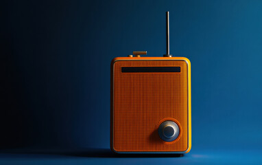 Obraz premium A 1960s style transistor radio in vibrant orange, standing upright against a deep blue space. 