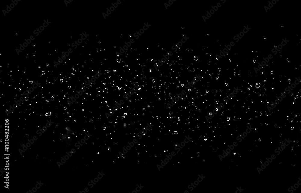 Poster Raindrops falling against a dark background creating a tranquil and soothing atmosphere during nighttime
