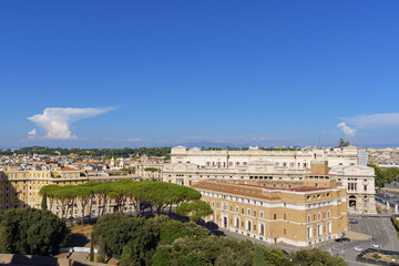 Fototapeta premium View from Castel Sant Angelo to a surrounding Park with huge pine trees in Rome Italy with a deep blue sky and an interesting looking cloud 
