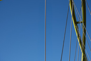 Obraz premium Minimalistic close up of a modern bridge structure against a vibrant blue sky