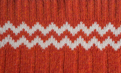 Fototapeta premium Red Knitted Christmas Sweater with Zigzag Pattern Background