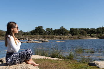 Young Woman in Lotus Pose Connecting with Nature