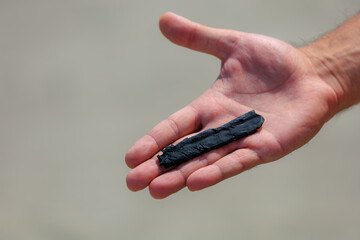 Hand Holding Piece of Tire Rubber Shredded During Drifting Event