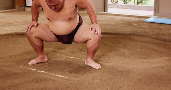 Legs, sumo wrestling and man with competition, training and fighting with practice. Professional, Japanese person and fighter in ring, wellness and pride with traditional culture, sports and prepare