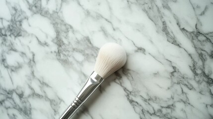 Makeup brush resting on a marble surface in a well-lit room during daylight hours