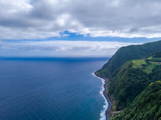 Fototapeta premium Aerial drone view of Sao Miguel island landscape with coast cliff from Miradouro da Ponta do Sossego Nordeste viewpoint. Azores archipelago, Portugal