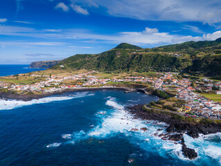Fototapeta premium Rocks, cliffs, waves and turquoise water in Atlantic ocean, Mosteiros, Azores islands. Aerial drone view of Acores archipelago