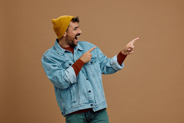 Studio shot of happy man pointing at side.