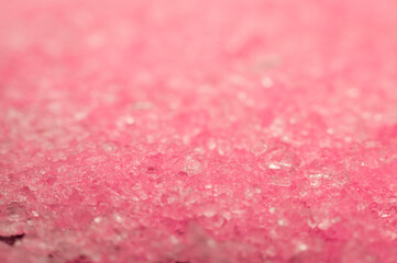 Close-up of sparkling pink crystals reflecting light in an abstract texture