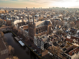 Canals of Amsterdam as seen from above with a drone. Drone photography of European cities. Amsterdam, Netherlands at sunset