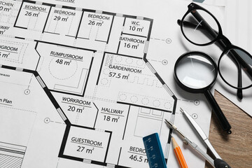 Different architectural drawings, pencil, dividers, ruler, glasses and magnifying glass on wooden table, top view