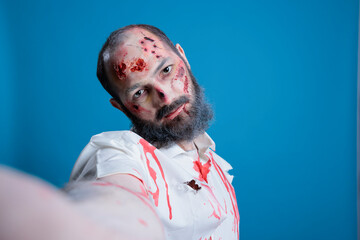 POV of creepy haunting flesh eating zombie taking selfies. Portrait of scary undead reanimated...