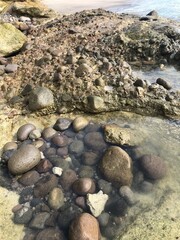beach with rocks, clear ocean water